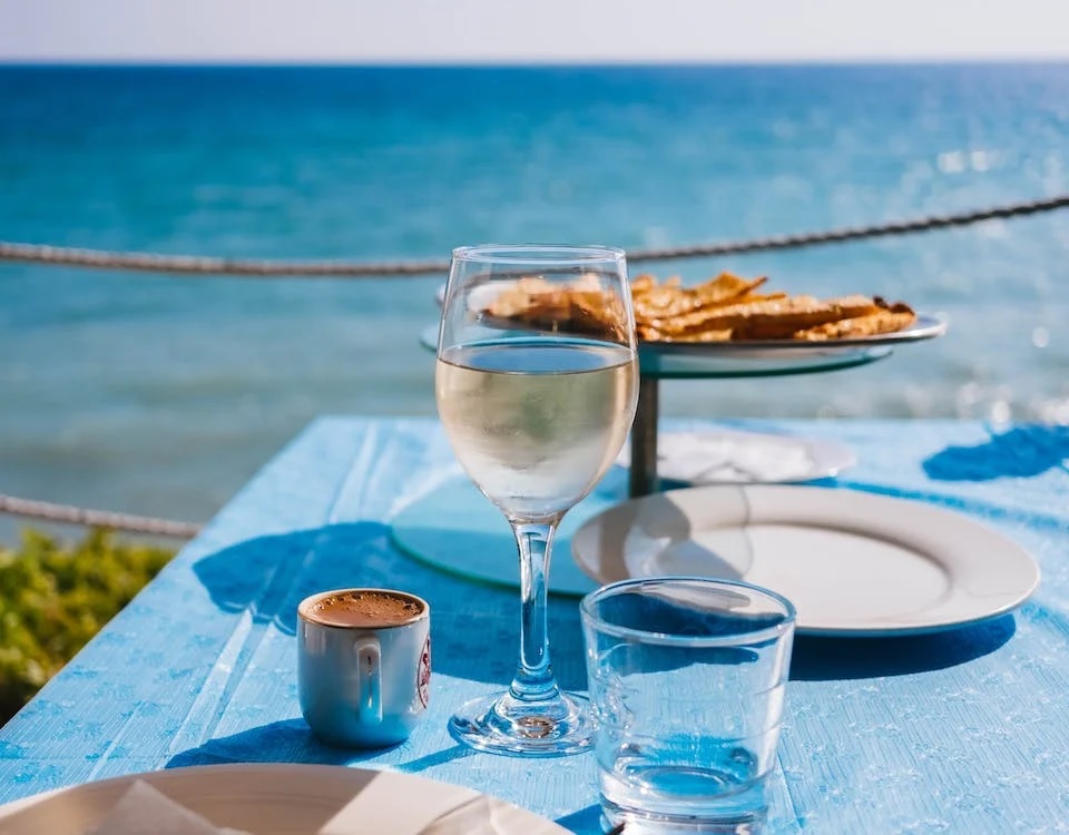 RentAndGo Zanzibar Car Rental - Image of a dish with a glass of wine on the beach